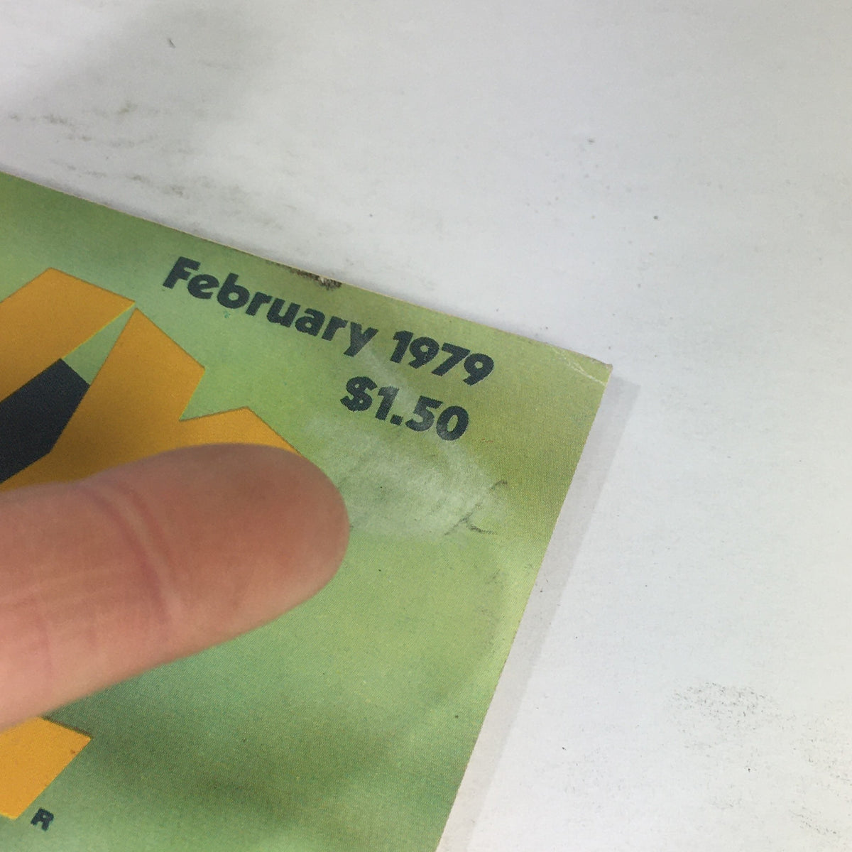 Close-up of the top corner of VTG Heavy Metal Magazine: February 1979 displaying the publication date and price of $1.50.