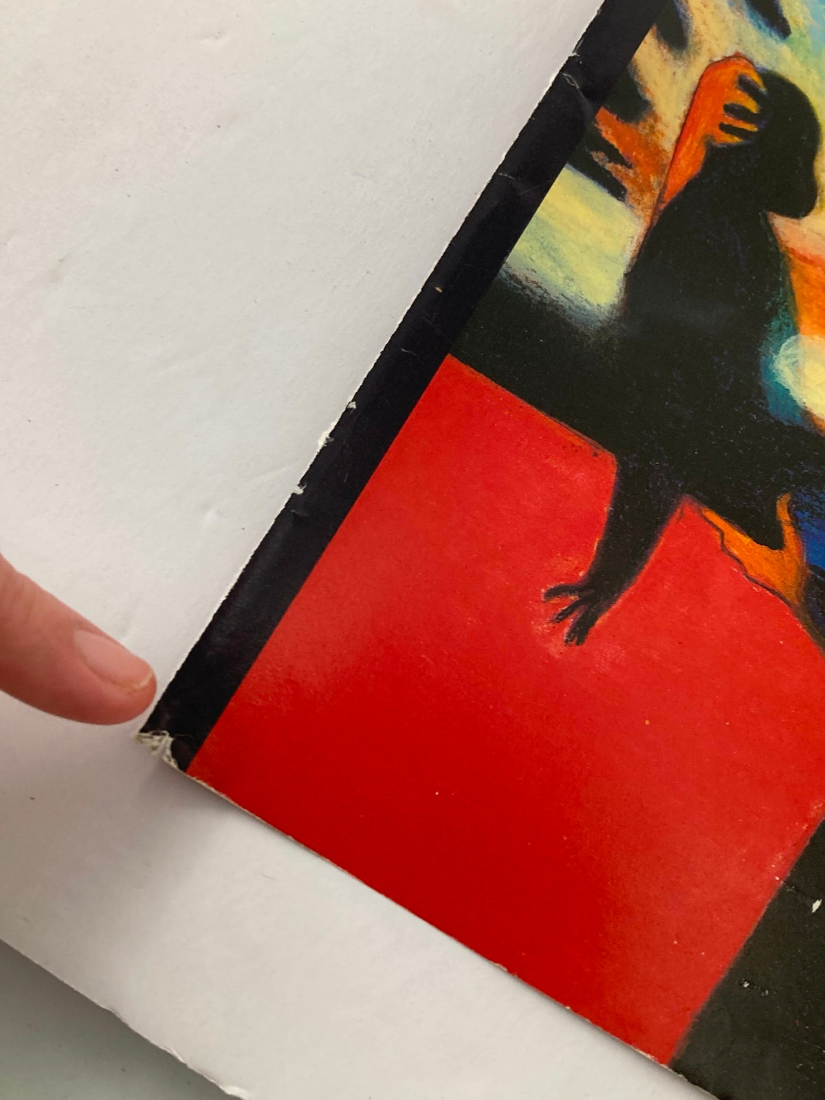 Detail of The New Yorker July 31 1995 cover art titled A Nuclear Blast by Lorenzo Mattotti, showing a hand pointing to the edge of the cover with minor wear, perfect for collectors and showcasing the iconic artwork.