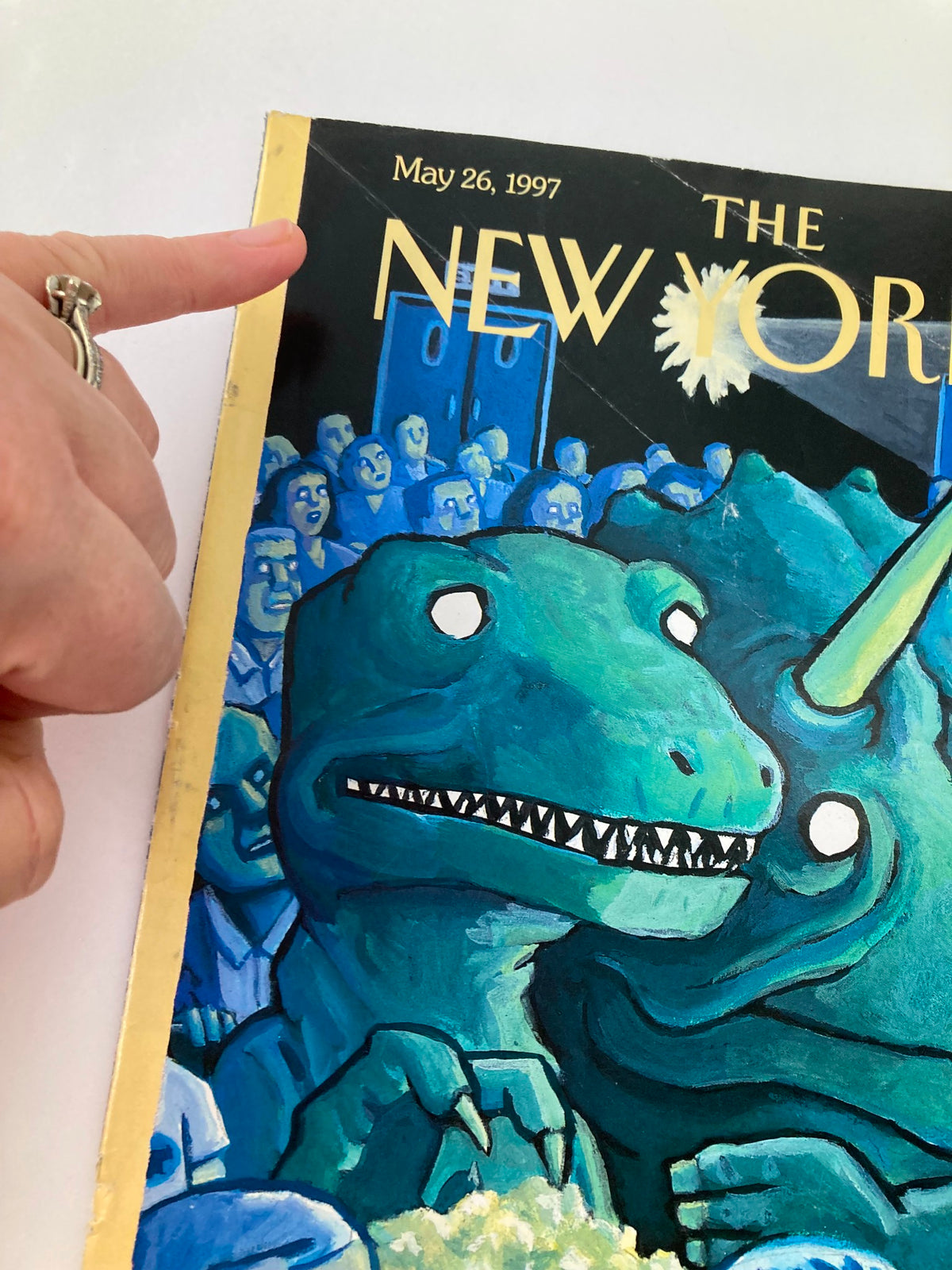 Detailed image of The New Yorker cover dated May 26, 1997, created by Art Spiegelman, focusing on the edge of the magazine with a hand pointing to highlight its artistic features and minor wear.
