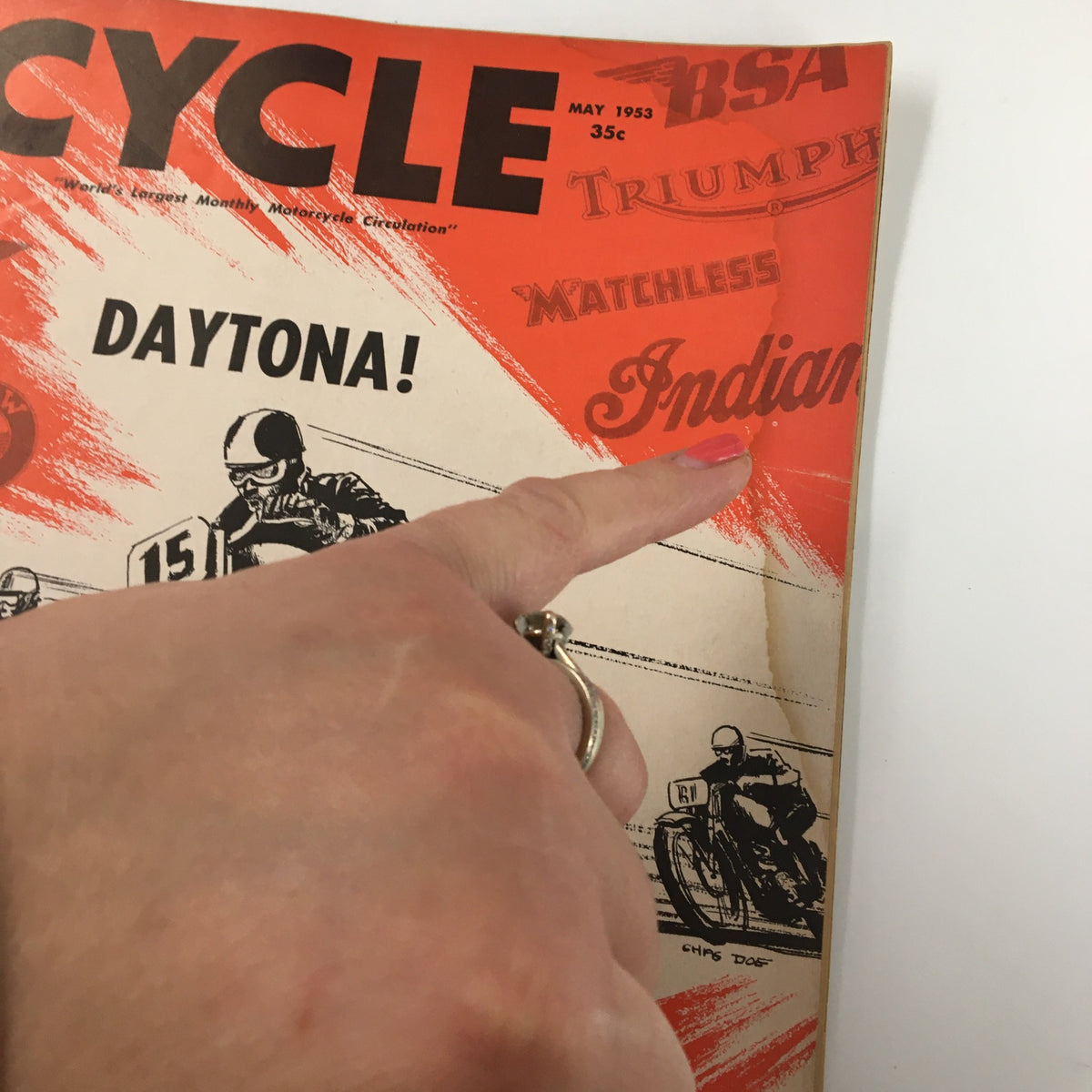 Cover of VTG Cycle Magazine May 1953 featuring the iconic title 'DAYTONA!' showcasing a hand pointing at the motorcycle brands, including Indian, Matchless, and Triumph.