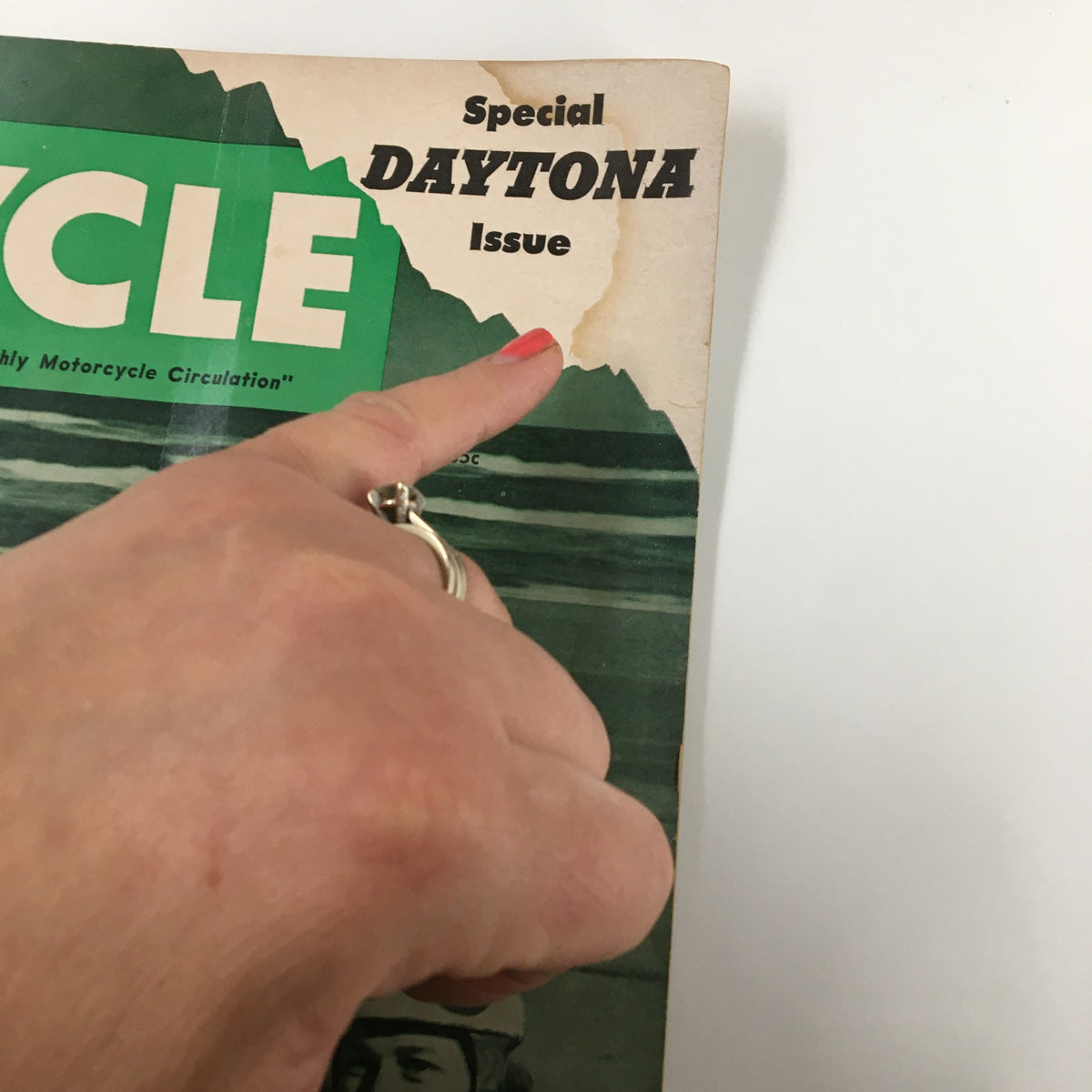 Close-up of the corner of VTG Cycle Magazine May 1954 illustrating the 'Special Daytona Issue' title and minor wear, perfect for collectors.