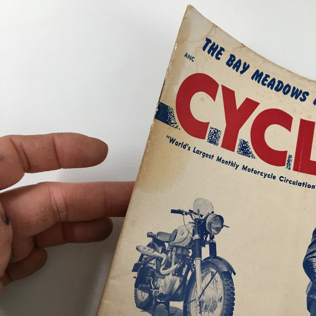 Side view of the VTG Cycle Magazine October 1954 showing the publication's title and art featuring a motorcycle, highlighting its vintage nature.
