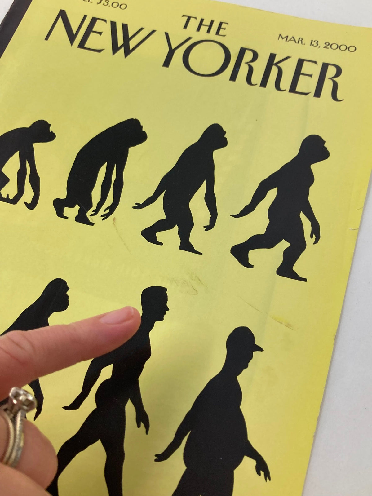 The New Yorker magazine cover from March 13, 2000, titled 'Time Marches On' by Ian Falconer, highlighting evolutionary figures in black against a vibrant yellow backdrop.