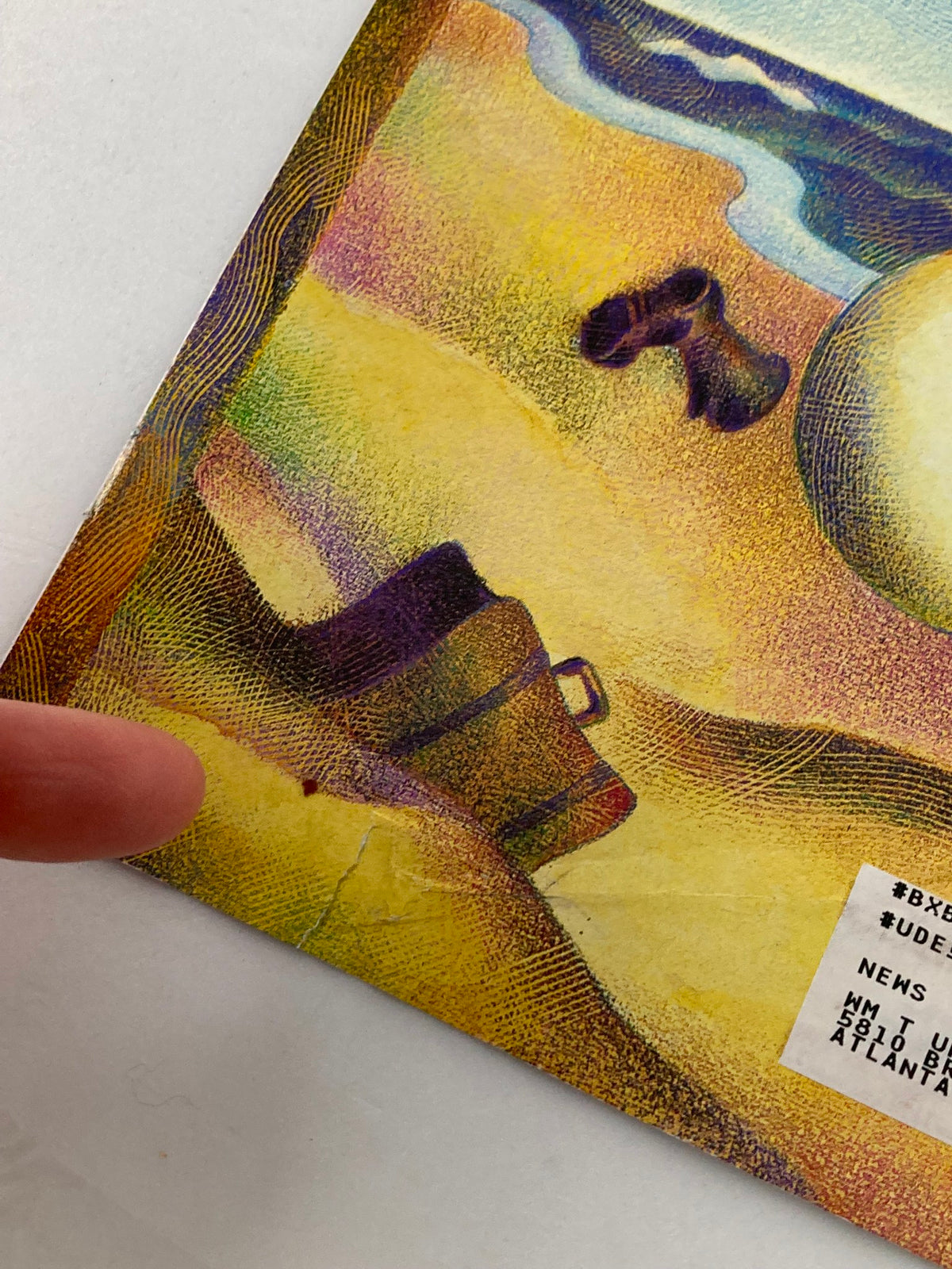 COVER ONLY The New Yorker March 27 2000 Winter is Sprung by Raul Colon, highlighting a close-up of a bag resting on a sandy beach, depicting wear and charm.