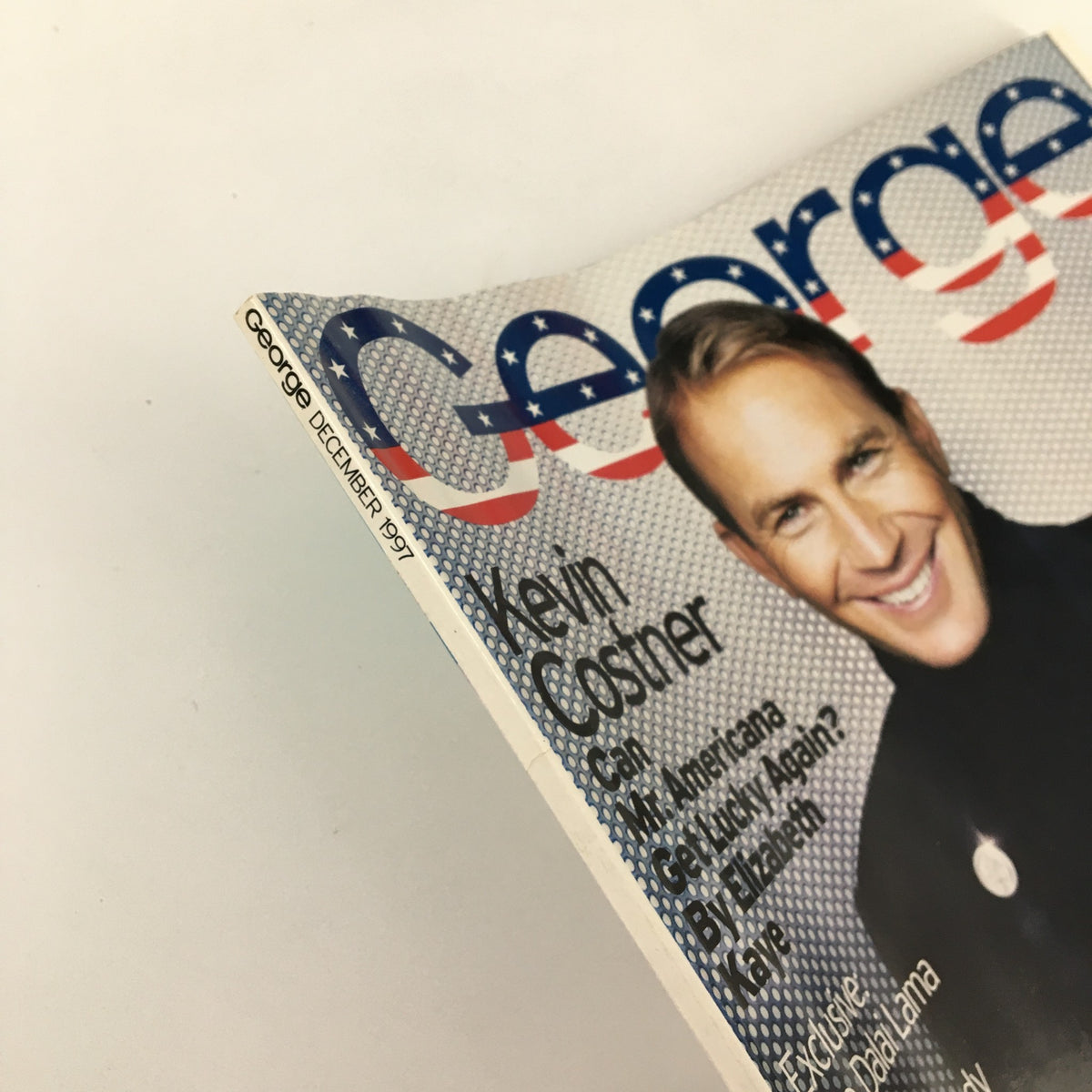 Close-up of the spine of George Magazine December 1997 featuring Kevin Costner on the cover and the magazine title.