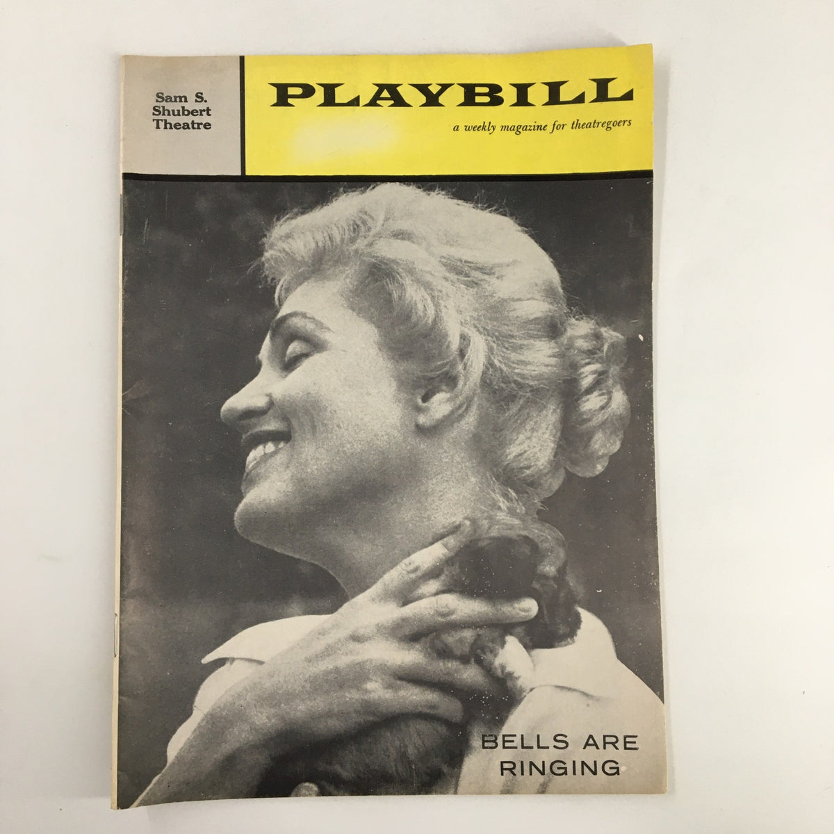 1959 Playbill for Judy Holliday in 'Bells Are Ringing' at Sam S. Shubert Theatre, featuring a black and white image of Judy Holliday smiling while holding a small dog.
