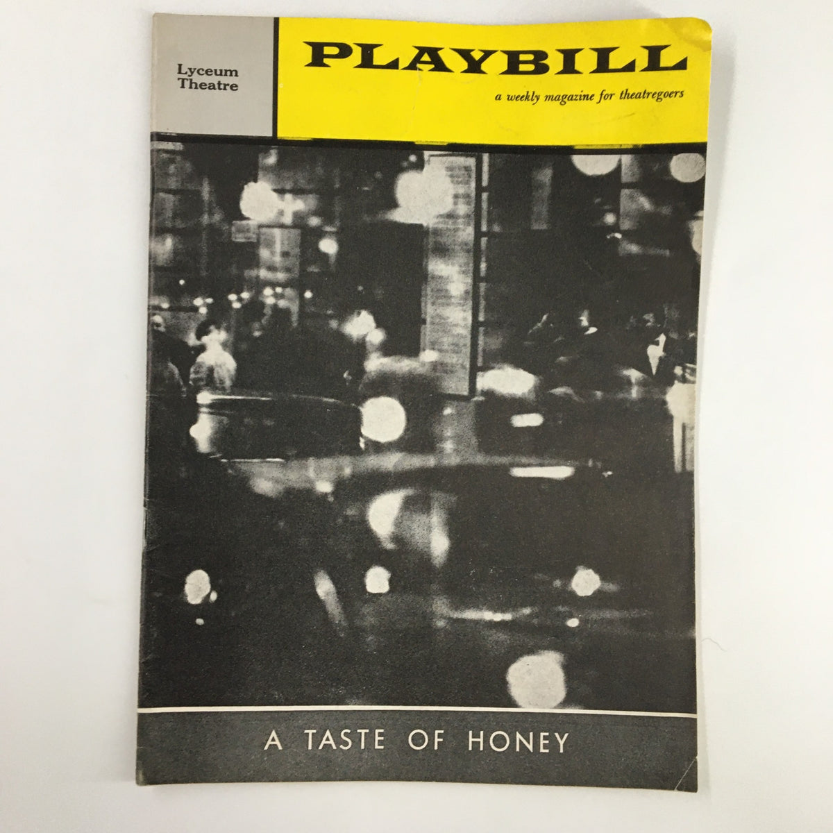 1960 Playbill for 'A Taste of Honey' at Lyceum Theatre featuring a dimly lit city scene.