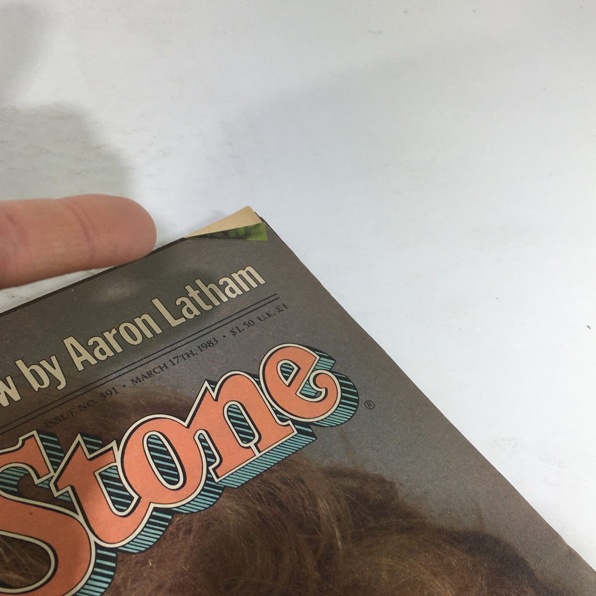 Corner detail of the VTG Rolling Stone magazine from March 17, 1983, showing the top edge with a folded corner, part of the cover featuring the headline 'Rolling Stone' and indicating its vintage condition.