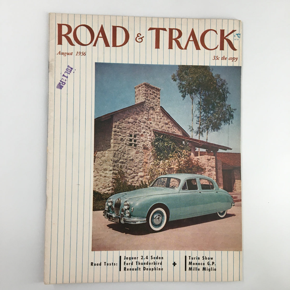 Cover of VTG Road & Track Magazine August 1956 showcasing a Jaguar 2.4 Sedan parked in front of a stone house, featuring details about the Ford Thunderbird and Renault Dauphine.