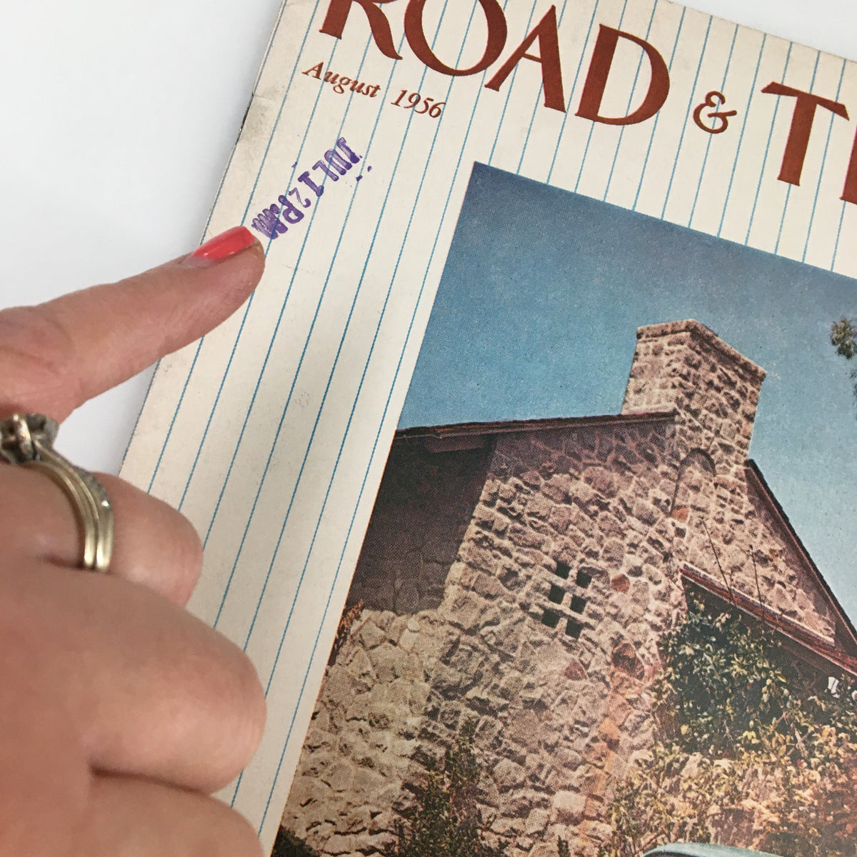 Close-up of the cover of VTG Road & Track Magazine August 1956 with a focus on the date and cover design, highlighting the Jaguar 2.4 Sedan.