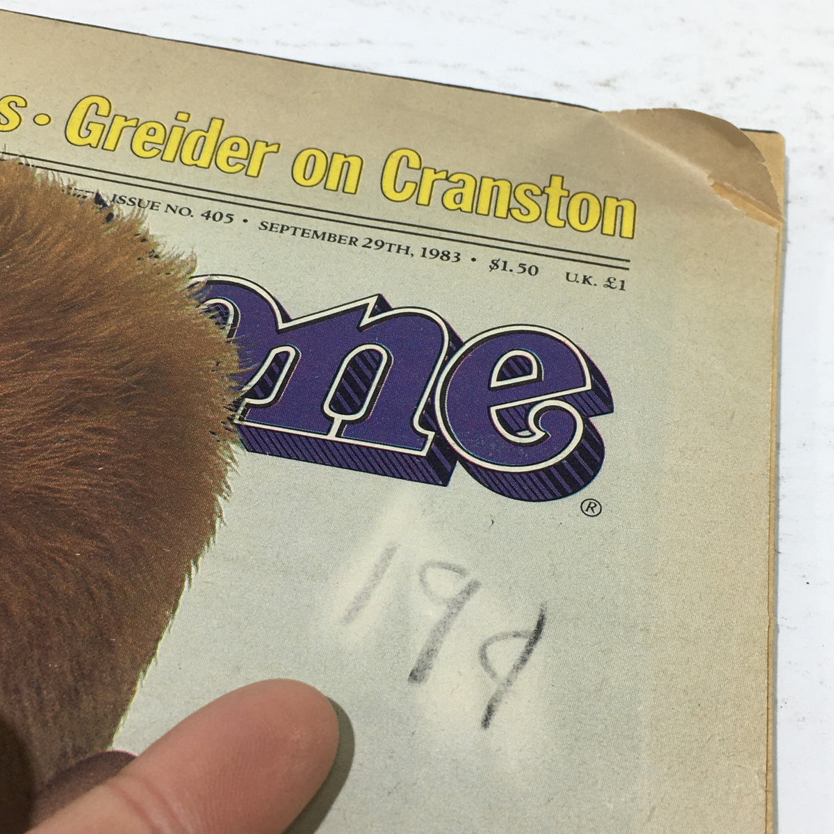 Image of the top corner of VTG Rolling Stone: September 29 1983 - Annie Lennox Cover, showcasing the magazine's title with a slight fold and a handwritten note.