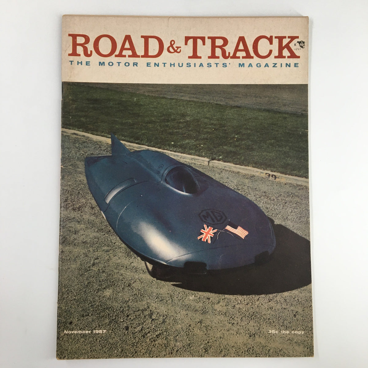 VTG Road & Track Magazine November 1957 featuring an illustration of a sleek blue sports car on the cover, emphasizing classic automotive design.