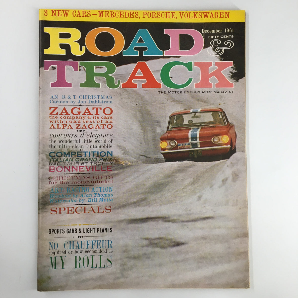 Cover of VTG Road & Track Magazine December 1961 featuring a colorful title and an image of a classic car driving through snow, highlighting topics on Mercedes, Porsche, and Volkswagen.
