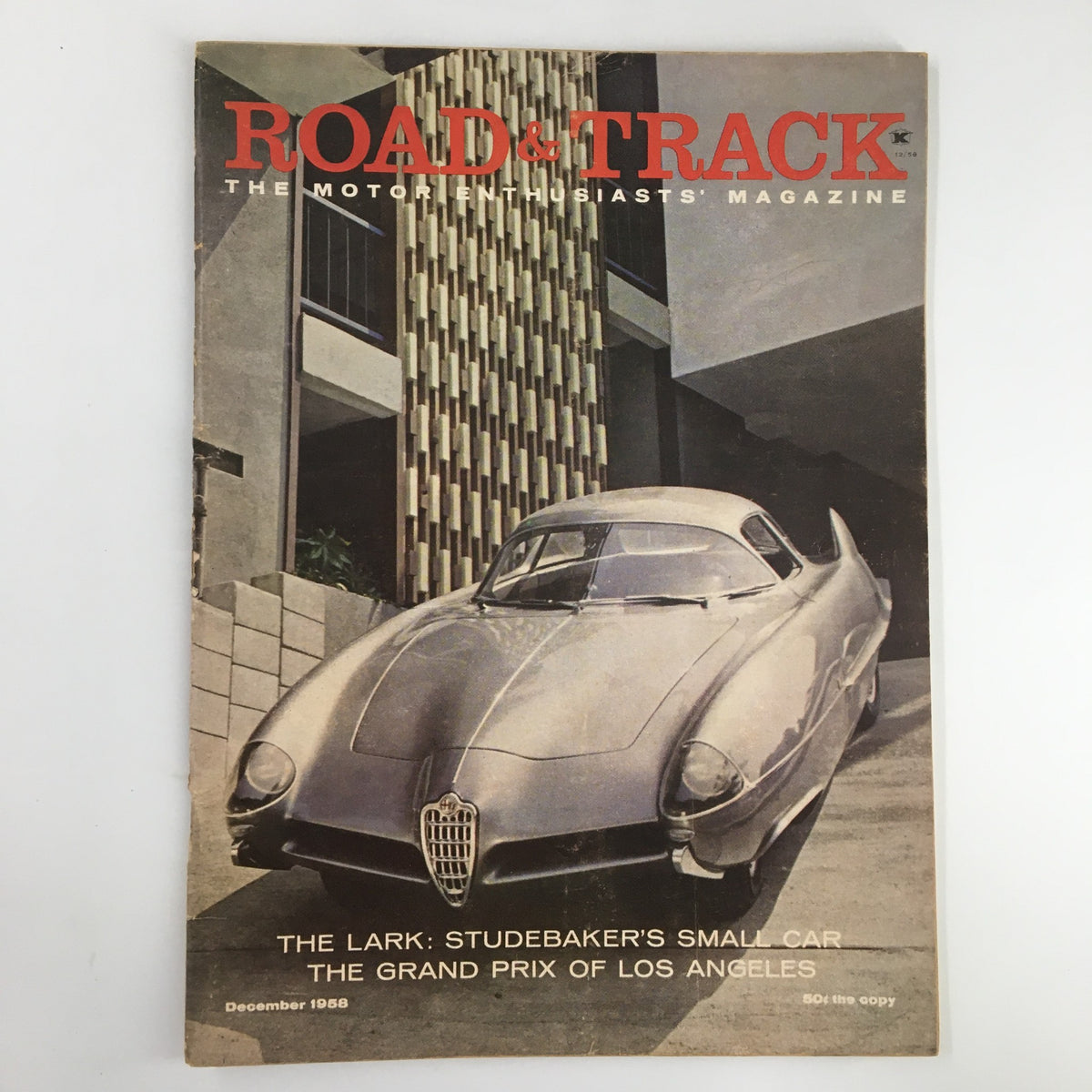 Road & Track magazine cover from December 1958 featuring the Lark Studebaker's Small Car and the Grand Prix of Los Angeles. The cover showcases a sleek vintage car design, reflecting mid-20th-century automotive engineering.