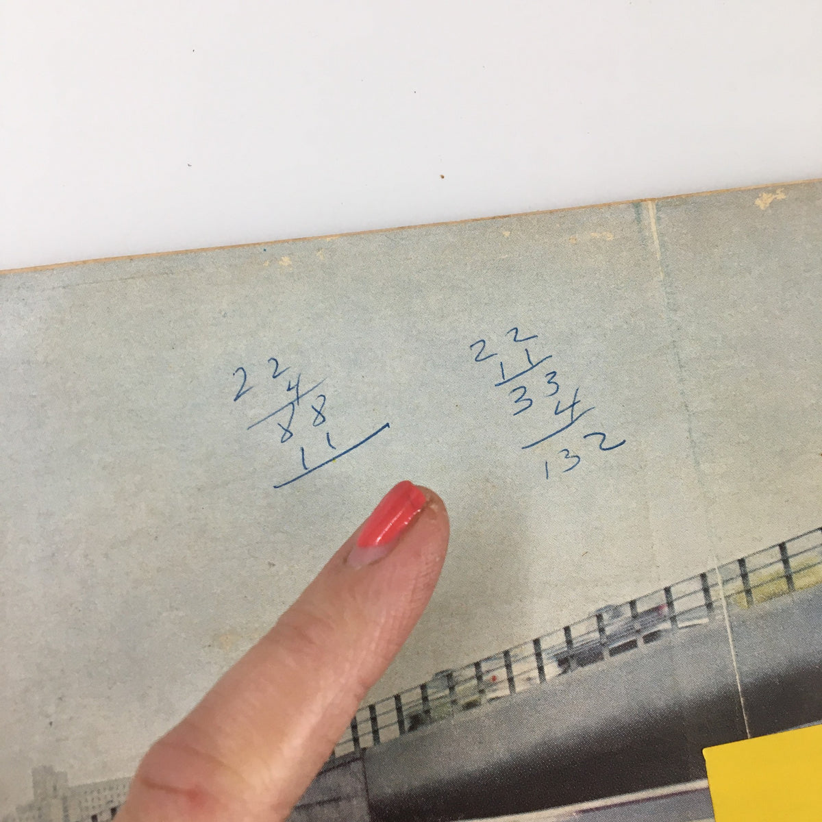 Close-up of handwritten calculations and notes on the back cover of the VTG Road & Track Magazine December 1958 featuring the Lark Studebreaker, showcasing insights into automobile history.