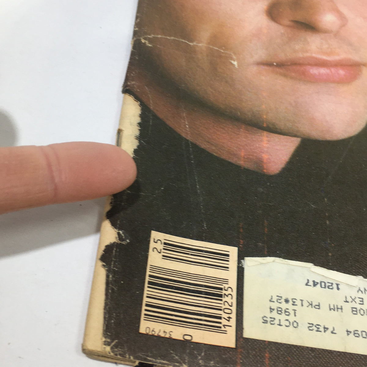 Close-up view of the edge of the Vintage Rolling Stone Magazine from June 23, 1983, featuring Men At Work, highlighting imperfections like rips and faded areas.
