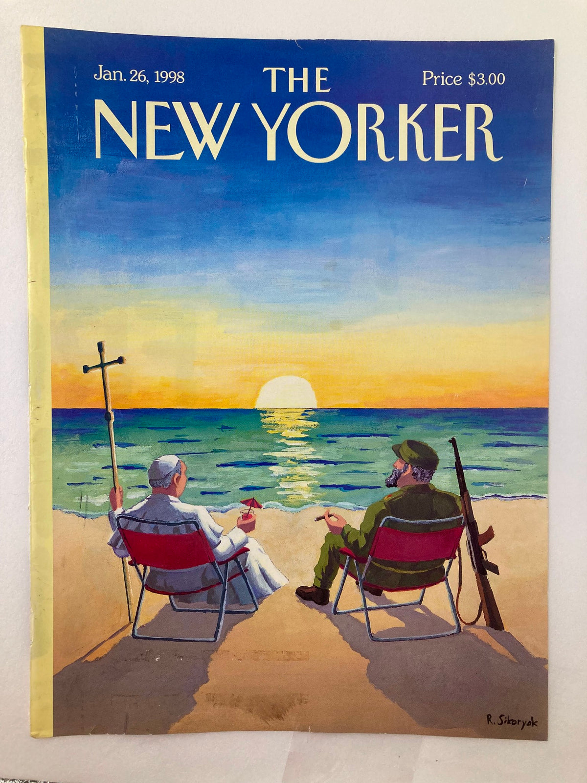 Cover of The New Yorker dated January 26, 1998, featuring an illustration by Robert Sikoryak depicting Pope John Paul II and Fidel Castro sitting on a beach at sunset, highlighting cultural and historical significance.