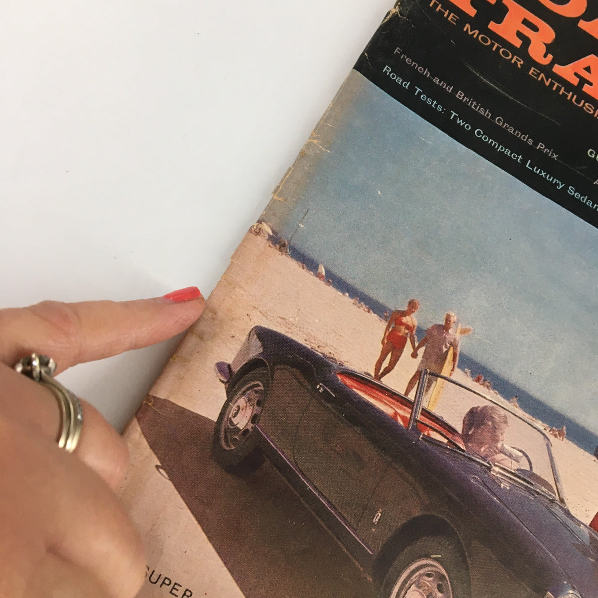 Close-up view of VTG Road & Track Magazine October 1959 cover highlighting the Alfa Super Spider with beach background.