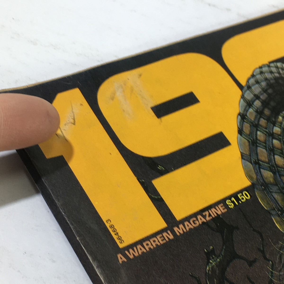 Close-up of the cover of VTG 1984 A Warren Magazine Number Five showing the magazine title and highlighting minor wear and imperfections on the surface.