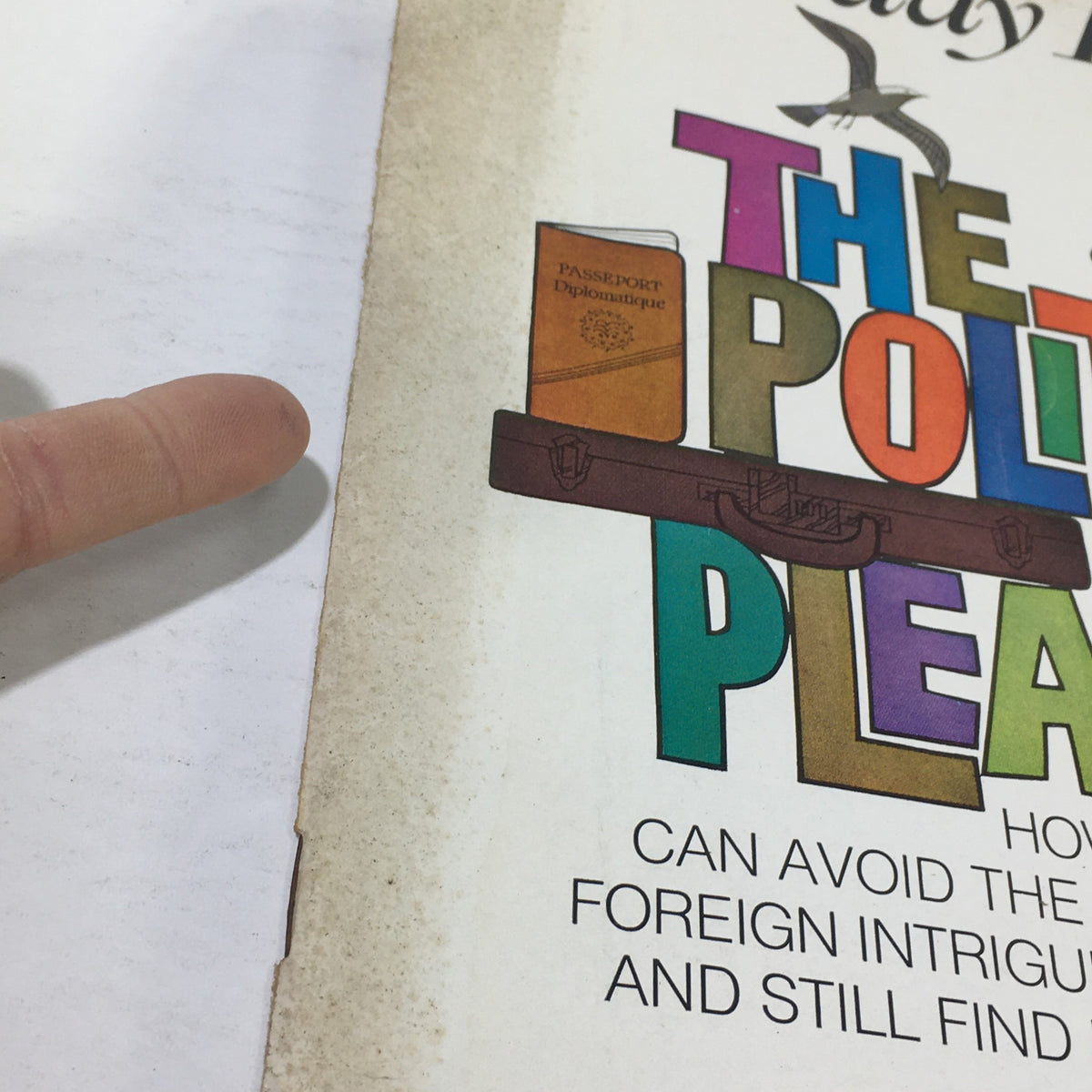 Close-up of the VTG Saturday Review: January 2 1971 - World Travel Issue cover, emphasizing the colorful title 'The Politics of Pleasure' and the suitcase graphic.
