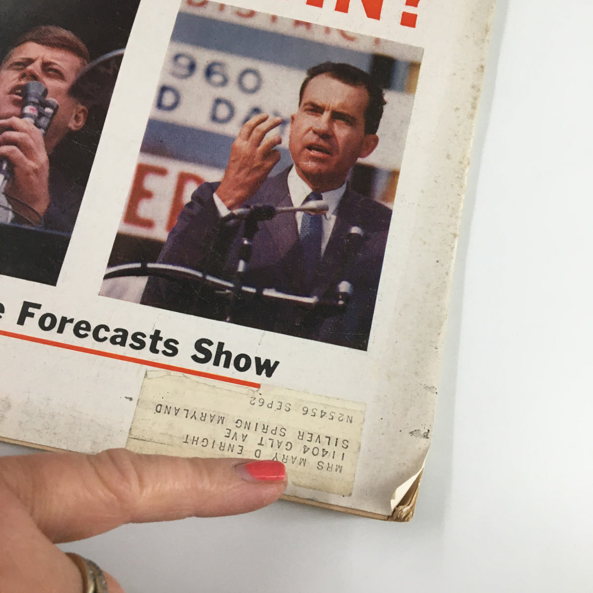Close-up of the cover of US News & World Report Magazine from November 7, 1960, highlighting John F. Kennedy and Richard Nixon during their presidential campaigns, with the title 'WHO'LL WIN?' and a label from a previous owner.