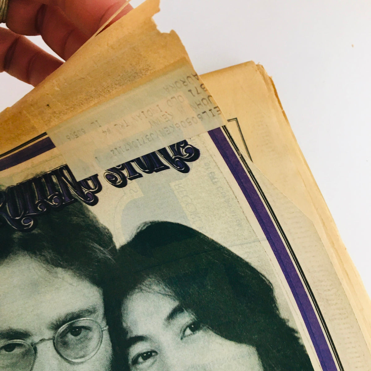 Close-up of the top left corner of Rolling Stone Magazine February 4, 1970, displaying the title and a small portion of John Lennon and Yoko Ono's faces.