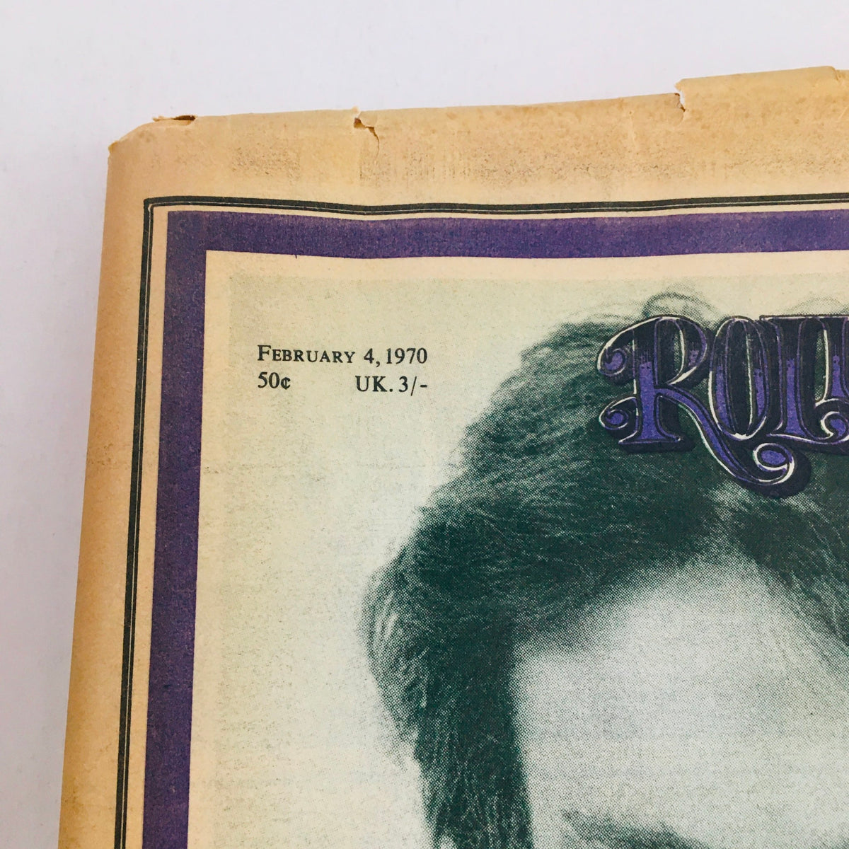 Top section of Rolling Stone Magazine February 4, 1970, showing the publication date and pricing along with a glimpse of John Lennon's hair.