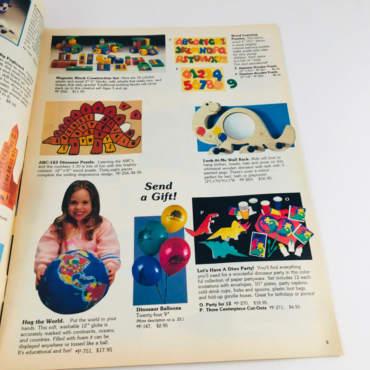 Interior page of Troll Summer 1988 Learn & Play Fun Toy Vintage Catalog showcasing educational toys, puzzles, and a girl holding a globe, surrounded by colorful toy images.