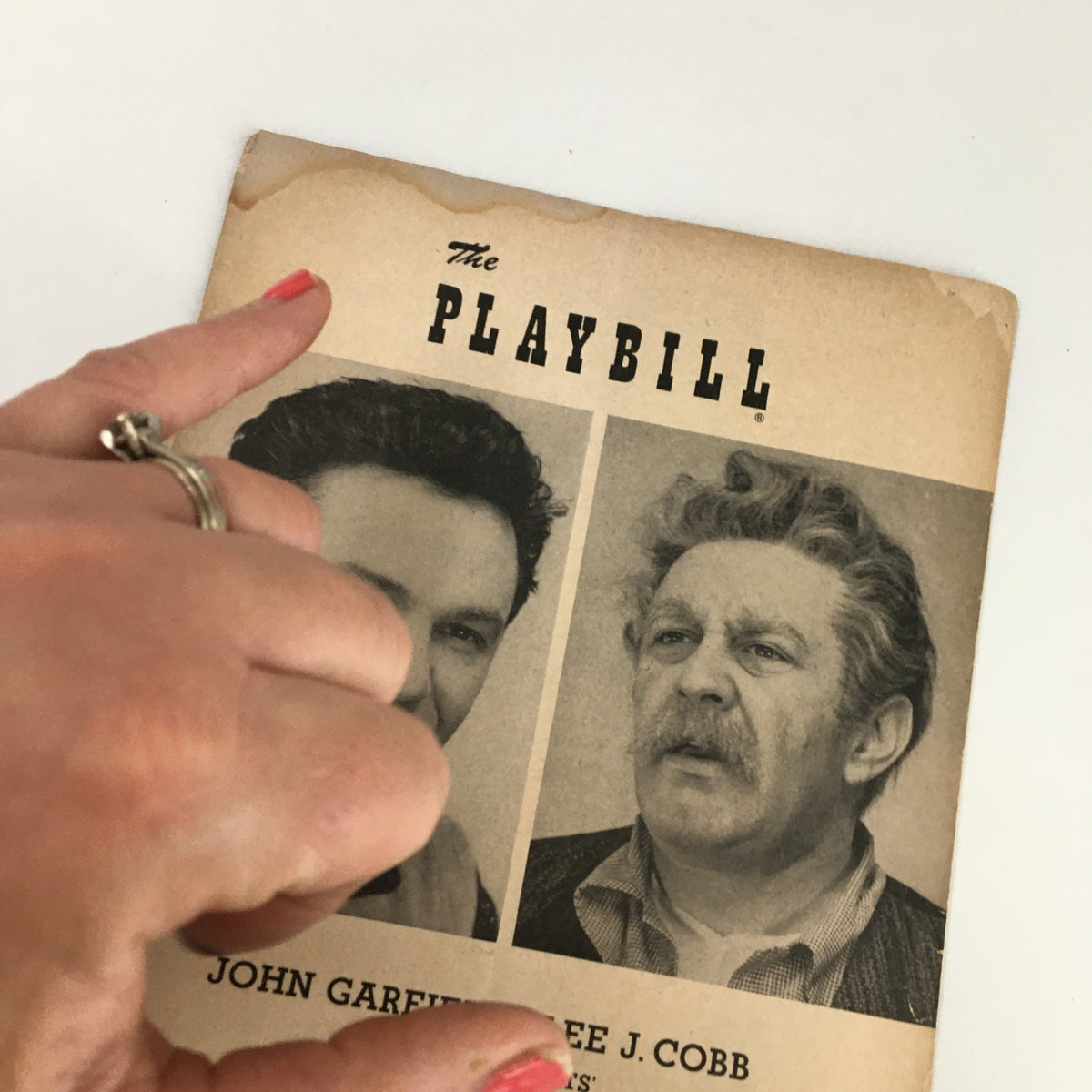 Close-up view of the 1952 Playbill featuring John Garfield and Lee J. Cobb in 'Golden Boy', highlighting the publication title and actors' names.