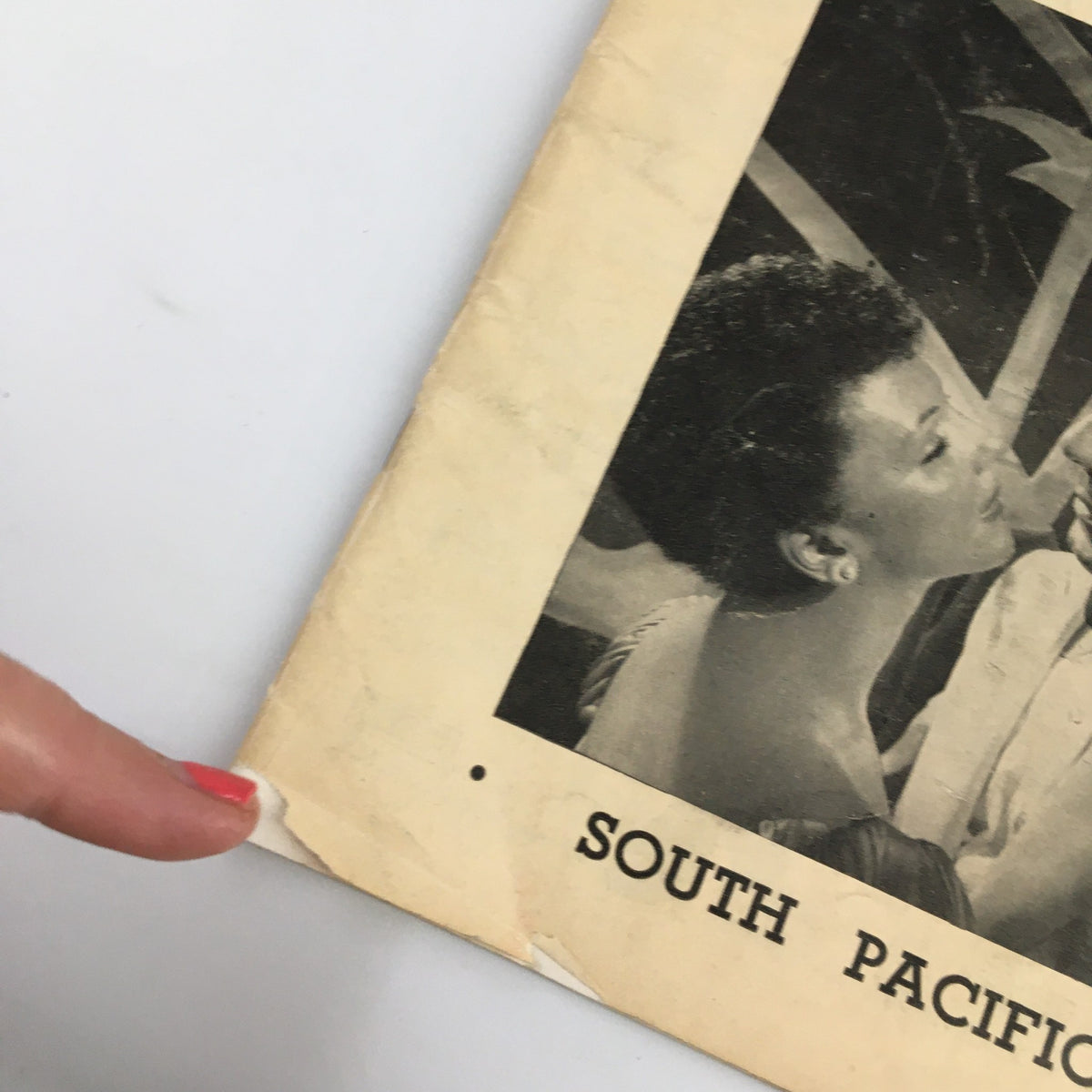 Close-up of the 1950 Playbill for the Majestic Theatre featuring South Pacific, highlighting the worn edge and vintage aesthetics of the iconic theater program.