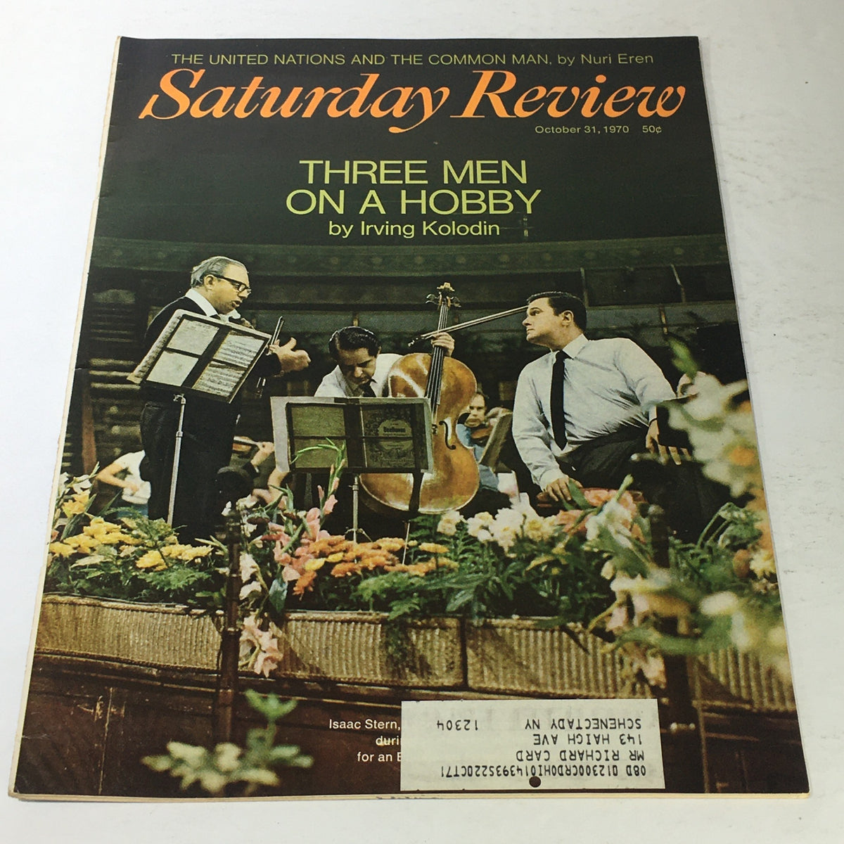 Cover of the vintage magazine Saturday Review dated October 31, 1970 featuring the article 'Three Men On A Hobby' by Irving Kolodin. The cover depicts three men engaged in musical activity with flowers in the foreground.
