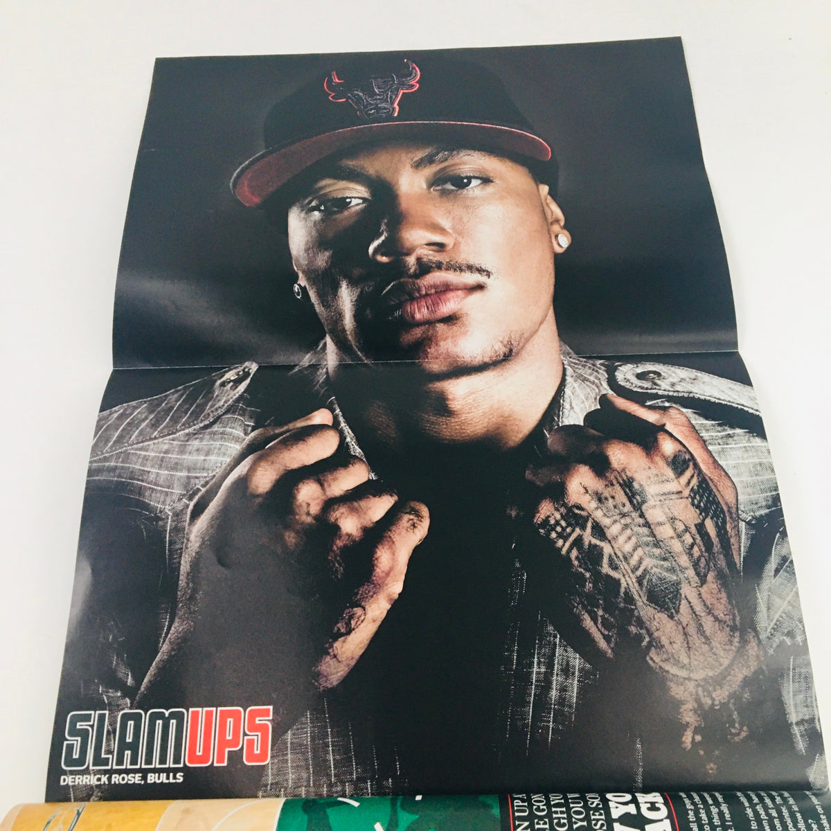 Poster included in Slam Magazine March 2010 #135, featuring a powerful portrait of Derrick Rose from the Chicago Bulls, emphasizing his athleticism and style.