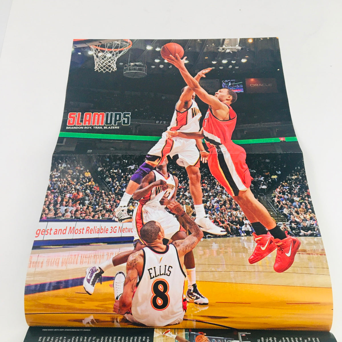 Poster in Slam Magazine March 2010 #135 showcasing Brandon Jennings in a dynamic play against the Portland Trail Blazers, capturing the excitement of NBA action.