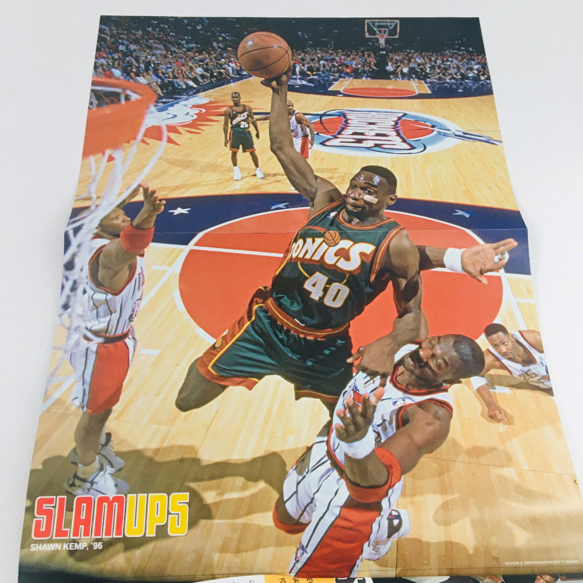 Slam Magazine 2009 Vol 16 #10 - Poster of Shawn Kemp making a dramatic dunk during a basketball game, showcasing athleticism in the sport.