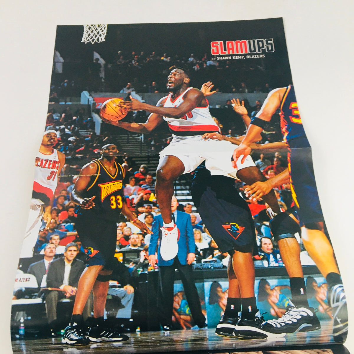 Slam Magazine February 2001 featuring Brooklyn Nets' Stephon Marbury, includes a poster of Shawn Kemp in action during a basketball game, showcasing dynamic gameplay.