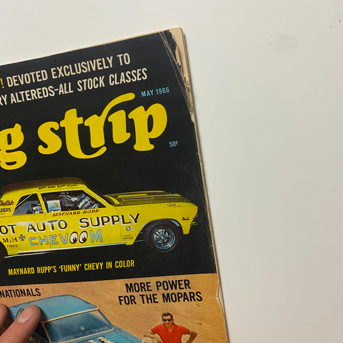 Close-up of the cover of VTG Drag Strip Magazine May 1966 showcasing Maynard Rupp's Funny Chevy, emphasizing the title and graphics.