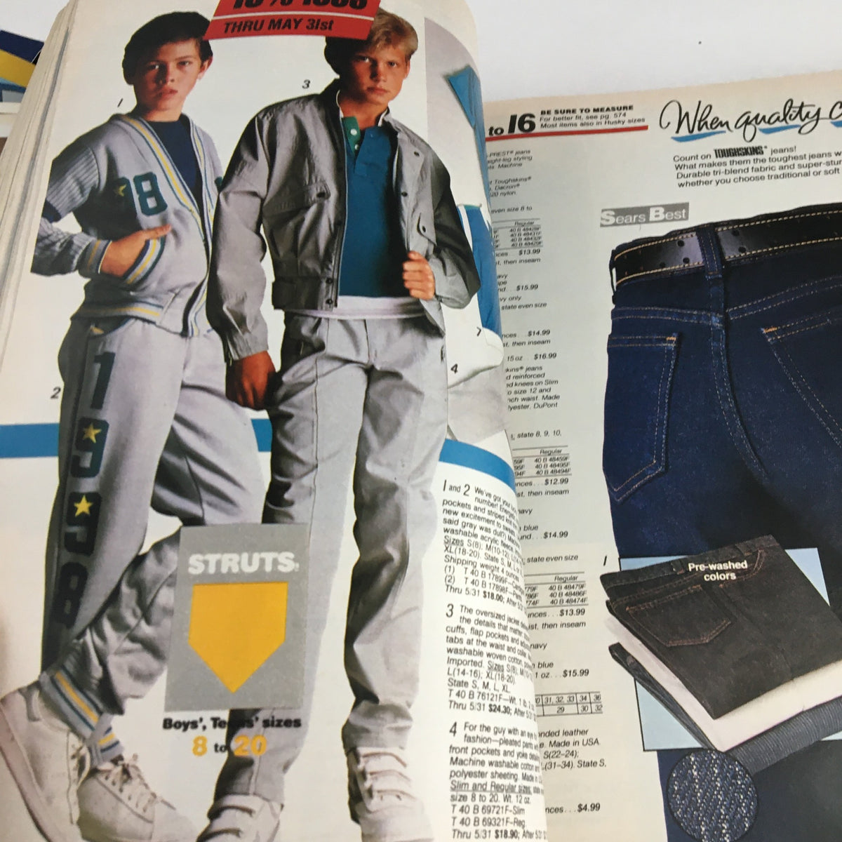 Two boys wearing sporty outfits, including jackets and sweatpants, featured in the VTG 1986 Centennial Edition Fashion Apparel & Home Furnishing Catalog.