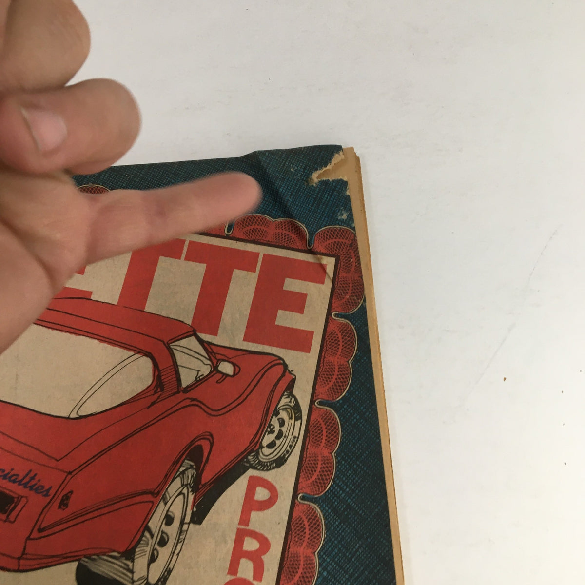 Close-up detail of the Corvette Products Fall & Winter 1983 1984 No. 160 Catalog cover, highlighting wear on the edge and a distinguished red Corvette.