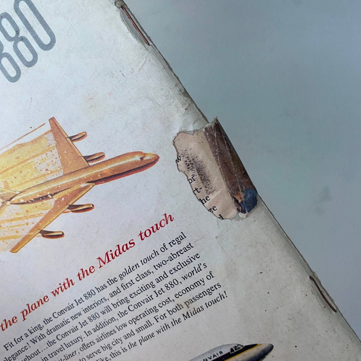 Close-up of a damaged area on the cover of US News & World Report Magazine February 21, 1958, showcasing wear and tear on this vintage publication, adding to its historical significance.