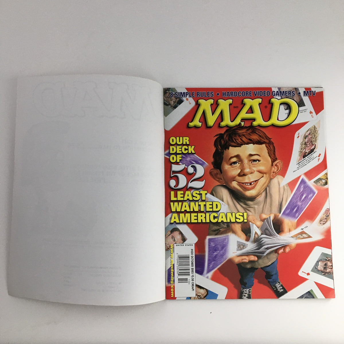Cover of Mad Magazine October 2003 #434, featuring the title 'MAD' and an illustration of a grinning character with 'Our Deck of 52 Least Wanted Americans!' caption, highlighting the magazine's humor.