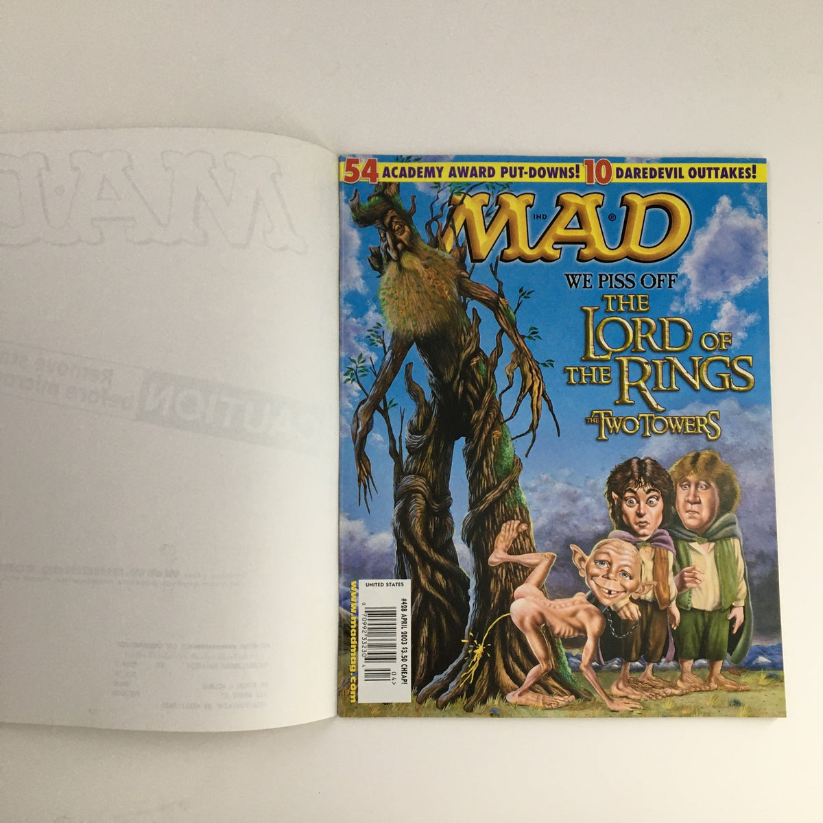 Mad Magazine April 2003 #428 featuring a humorous cover illustration inspired by Lord of the Rings: The Two Towers, showcasing characters in a comedic style.