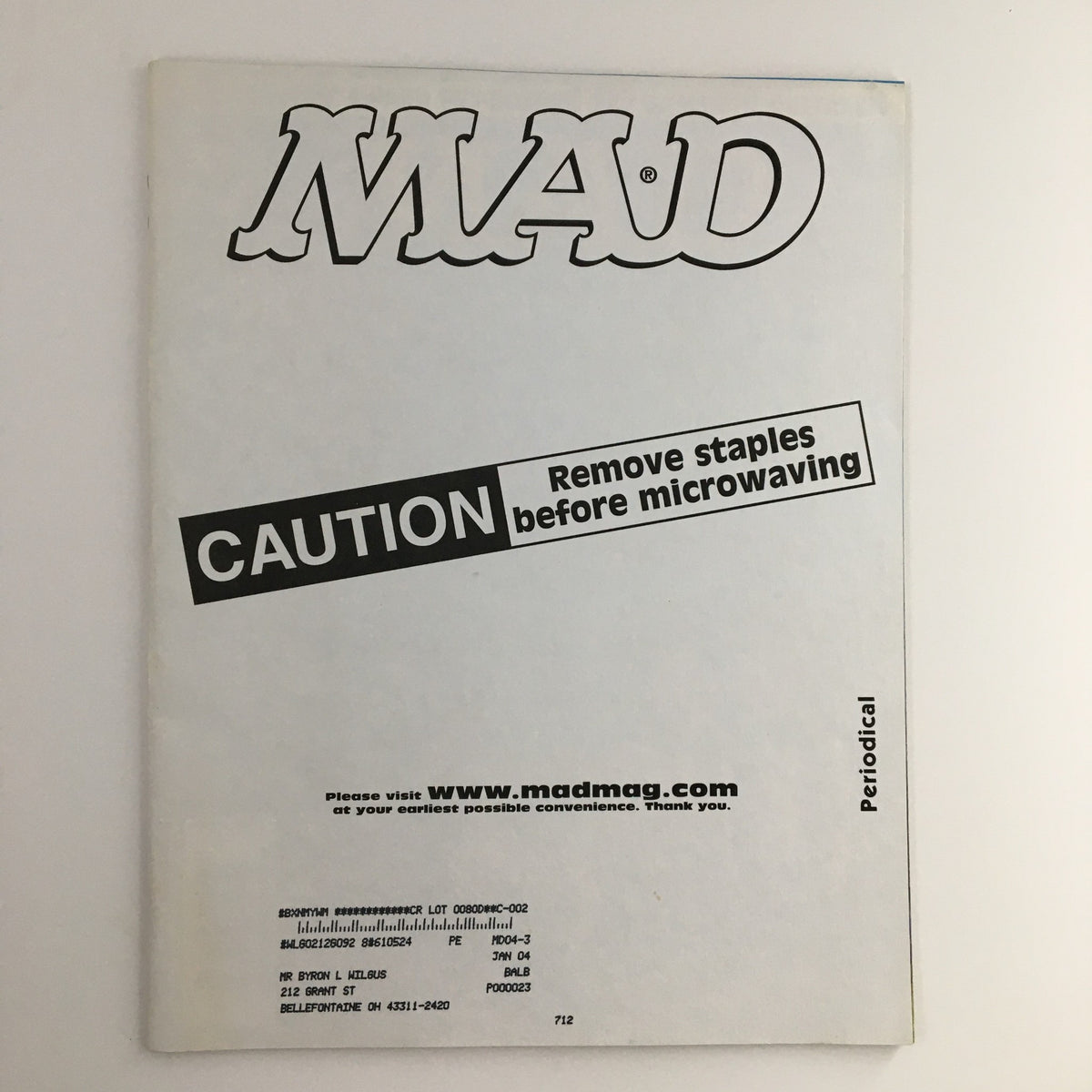 Back cover of Mad Magazine April 2003 #428 with a cautionary note about removing staples, highlighting its vintage appeal.
