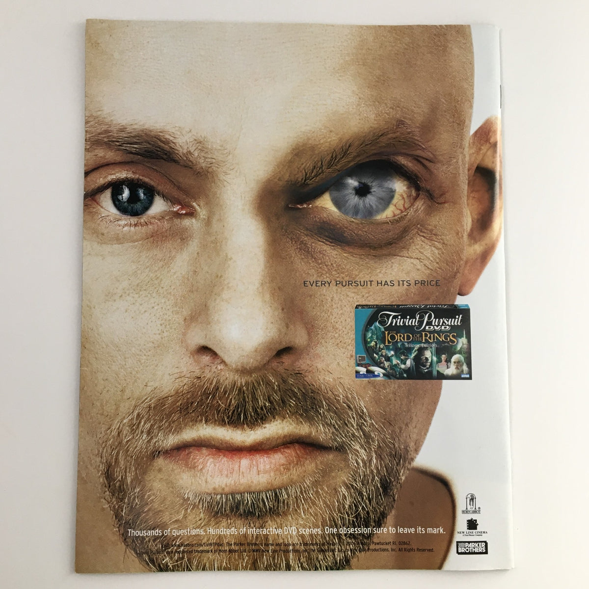 Back cover of Mad Magazine April 2005 #452 featuring a close-up of an expressive face with one eye unusual, promoting a connection to the game of Trivial Pursuit and the Lord of the Rings edition.