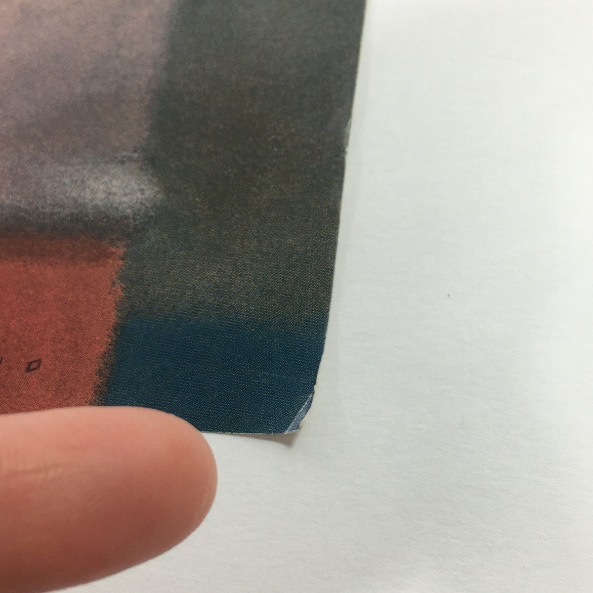 Close-up view of the worn edge of The New Yorker Magazine cover dated November 23, 1987, designed by Brad Holland.