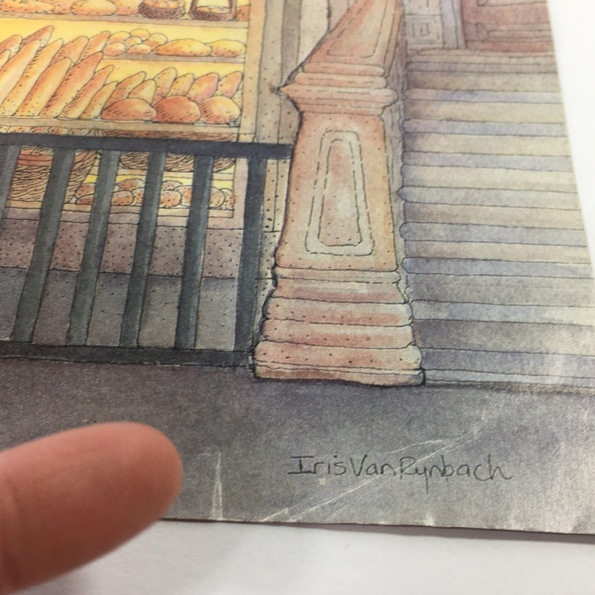 Detail shot of the New Yorker Magazine cover from March 30, 1987, illustrated by Iris Van Rynbach, highlighting the artist's signature and the bakery's intricately designed entrance.
