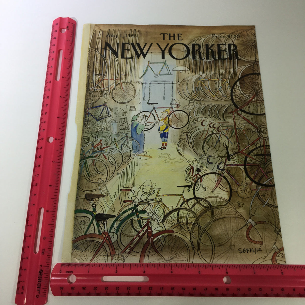 The New Yorker magazine cover from August 1, 1983, illustrated by Jean-Jacques Sempe, displayed next to a pink ruler for size reference, emphasizing its dimensions and vintage charm.
