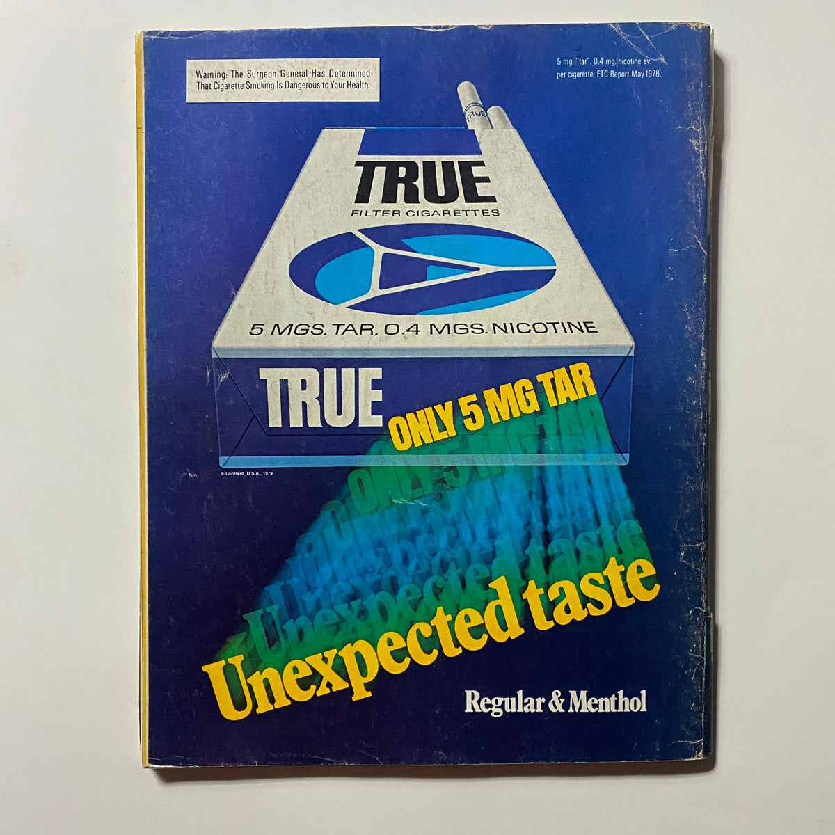 Advert for True Filter Cigarettes featured in a vintage magazine, showcasing the branding and health warning with the statement 'Only 5 MG Tar' and emphasizing the 'Unexpected Taste'.