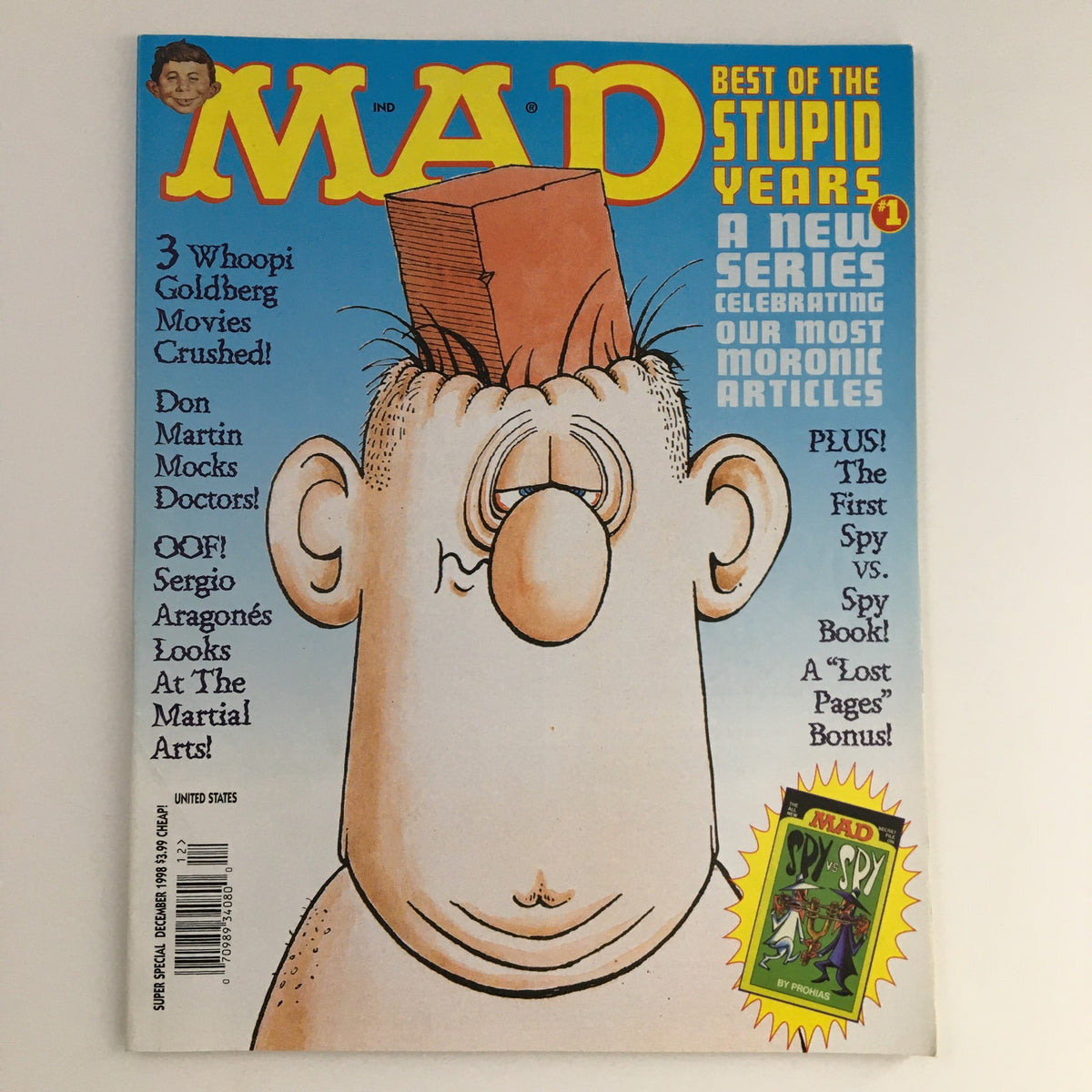 Mad Magazine December 1998 Super Special Best of the Stupid Years cover featuring a humorous illustration of a character with a block on his head, highlighting articles and content related to pop culture and satire.