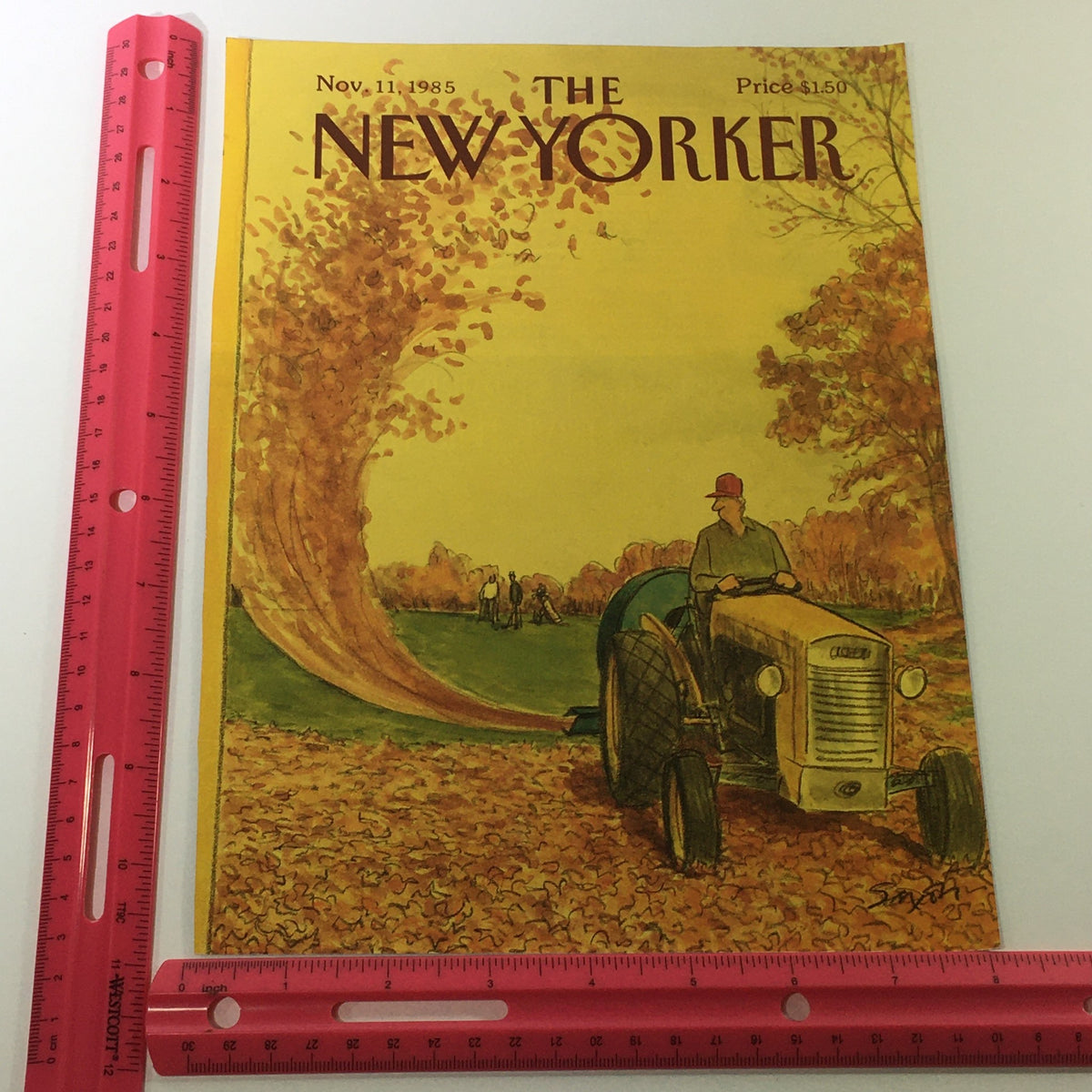 Cover of The New Yorker Magazine from November 11, 1985, with Charles Saxon's artwork displaying a tractor amidst falling leaves, shown alongside a ruler for size reference.