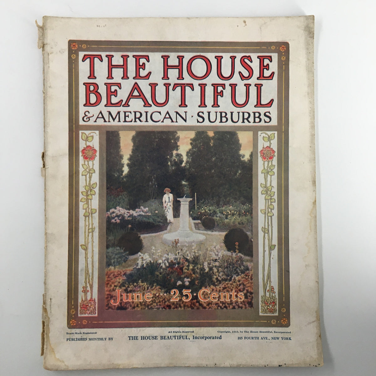 Cover of The House Beautiful Magazine June 1912 featuring a garden scene with a statue, illustrating early 20th-century design aesthetics.